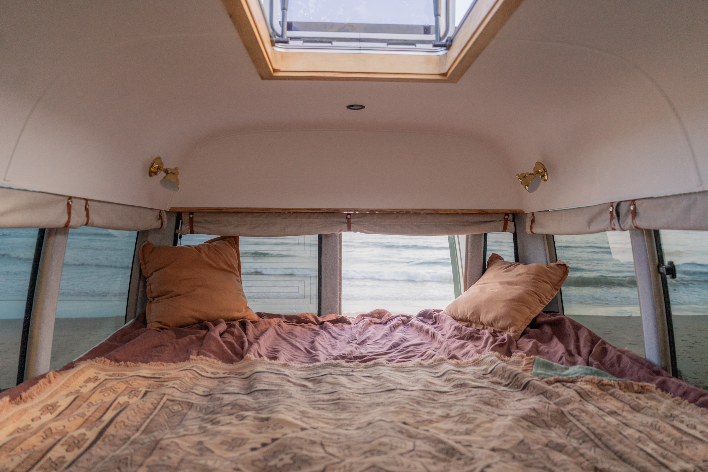 Sage bedroom with skylight and ocean beyond