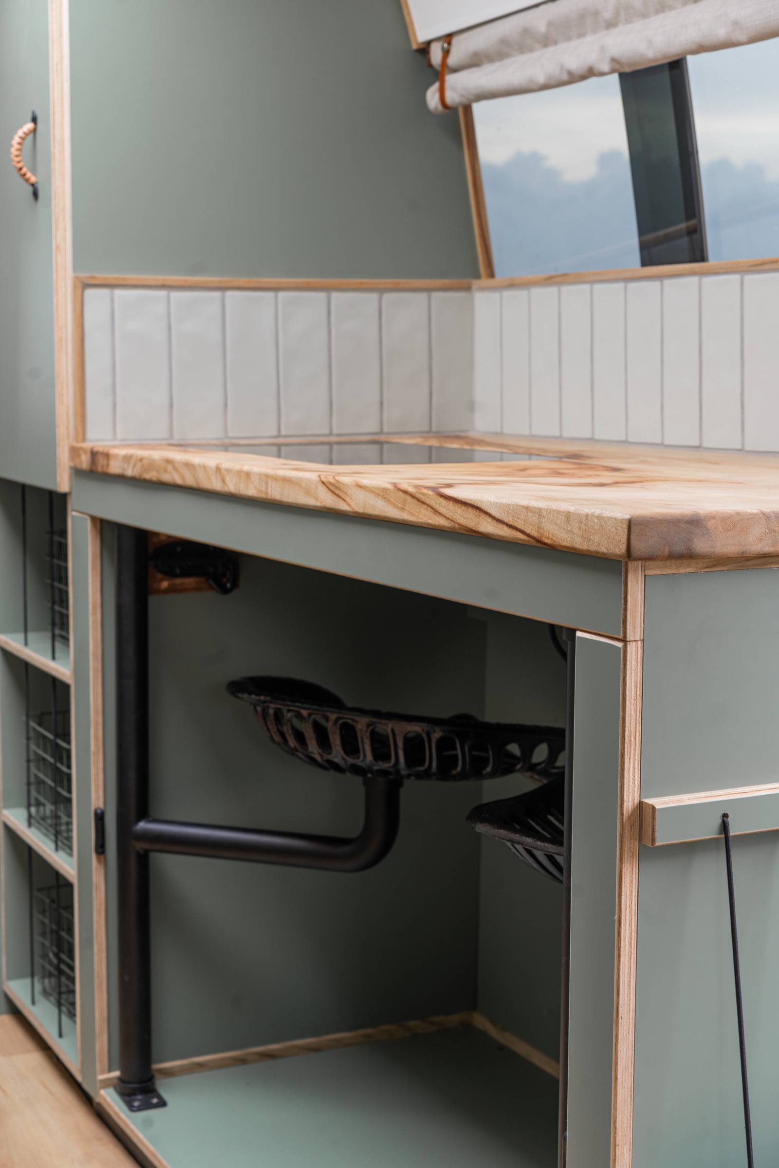 Sage green kitchen with timber details