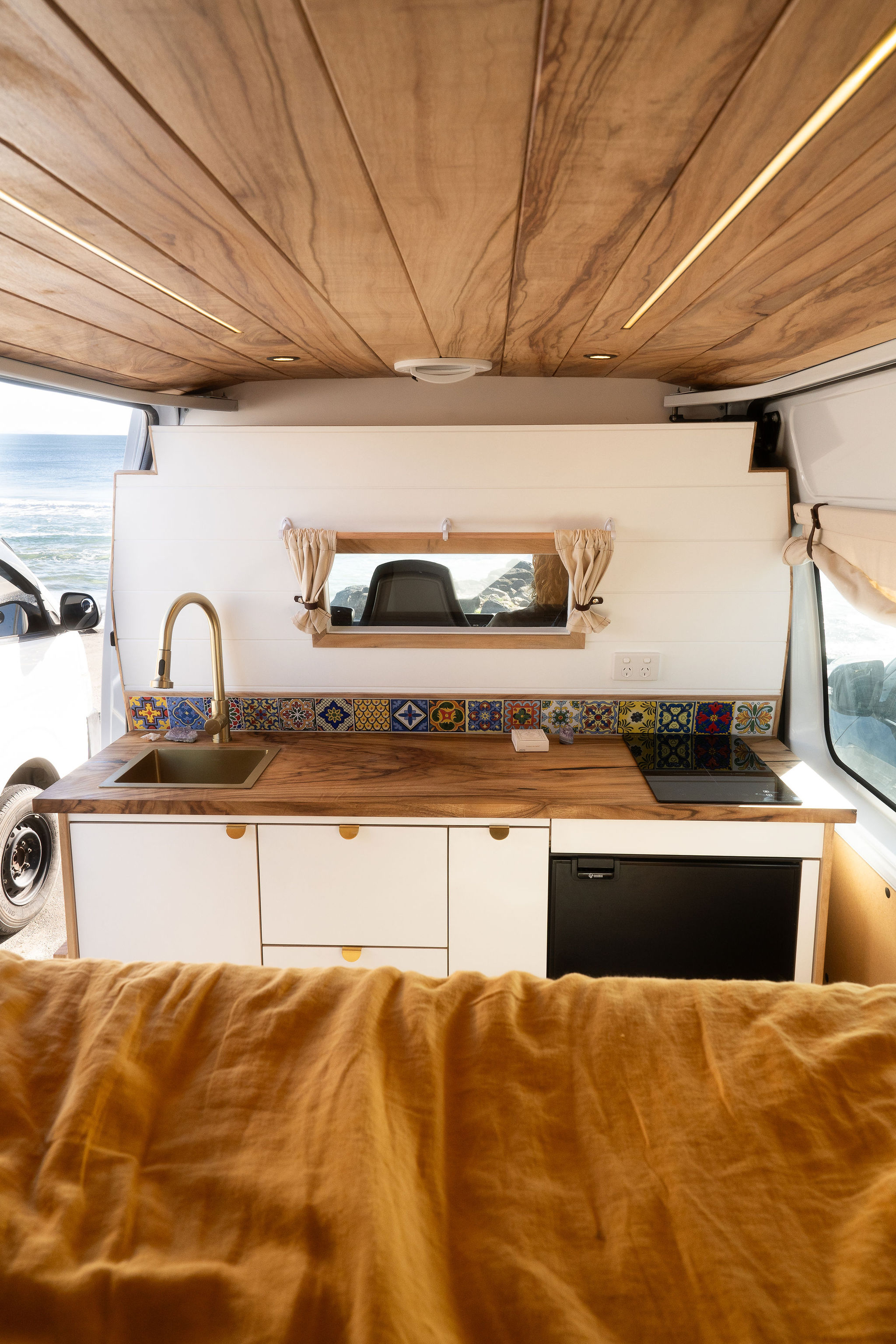 Warm timber ceiling and tiled kitchen inside Jasper